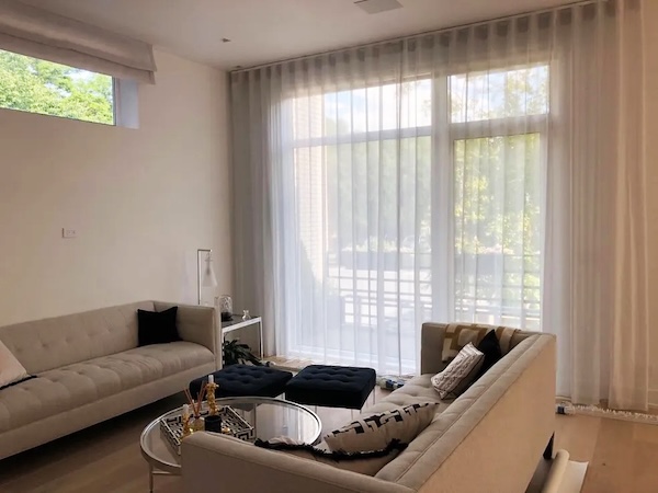 Elegant sheer curtains in front of a sliding glass window